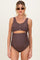 woman wearing a brown maternity swimsuit with scalloped trim and a cut-out detail, showing her baby bump