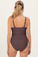 woman wearing a brown maternity swimwear with adjustable straps and a fitted design, viewed from the back