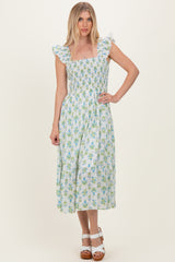 woman wearing a floral print midi dress with ruffle sleeves and smocked bodice