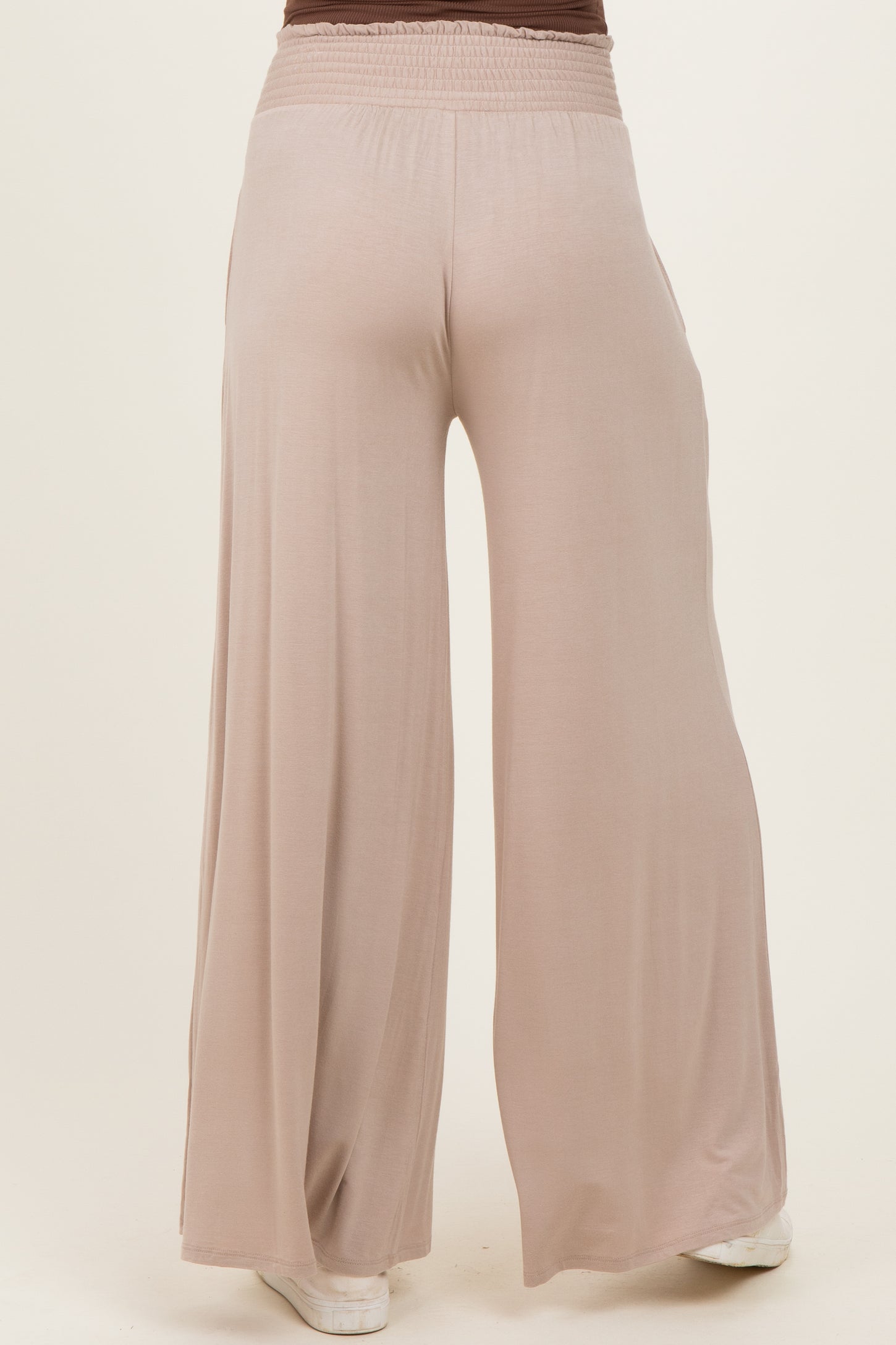maternity wear in soft beige wide-leg pants featuring an elastic waistband