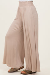 woman wearing light beige wide-leg pants with an elastic waistband and a relaxed fit