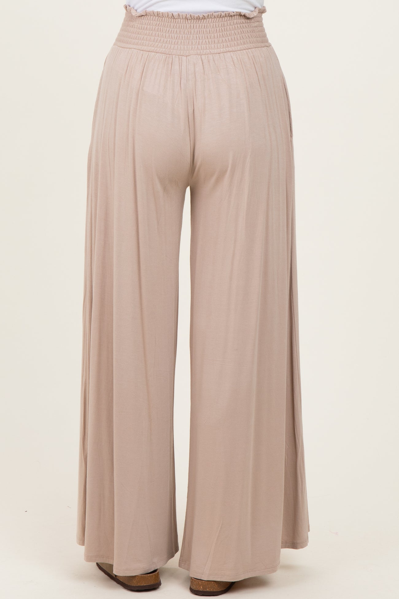 light beige wide-leg pants with an elastic waistband, viewed from the back