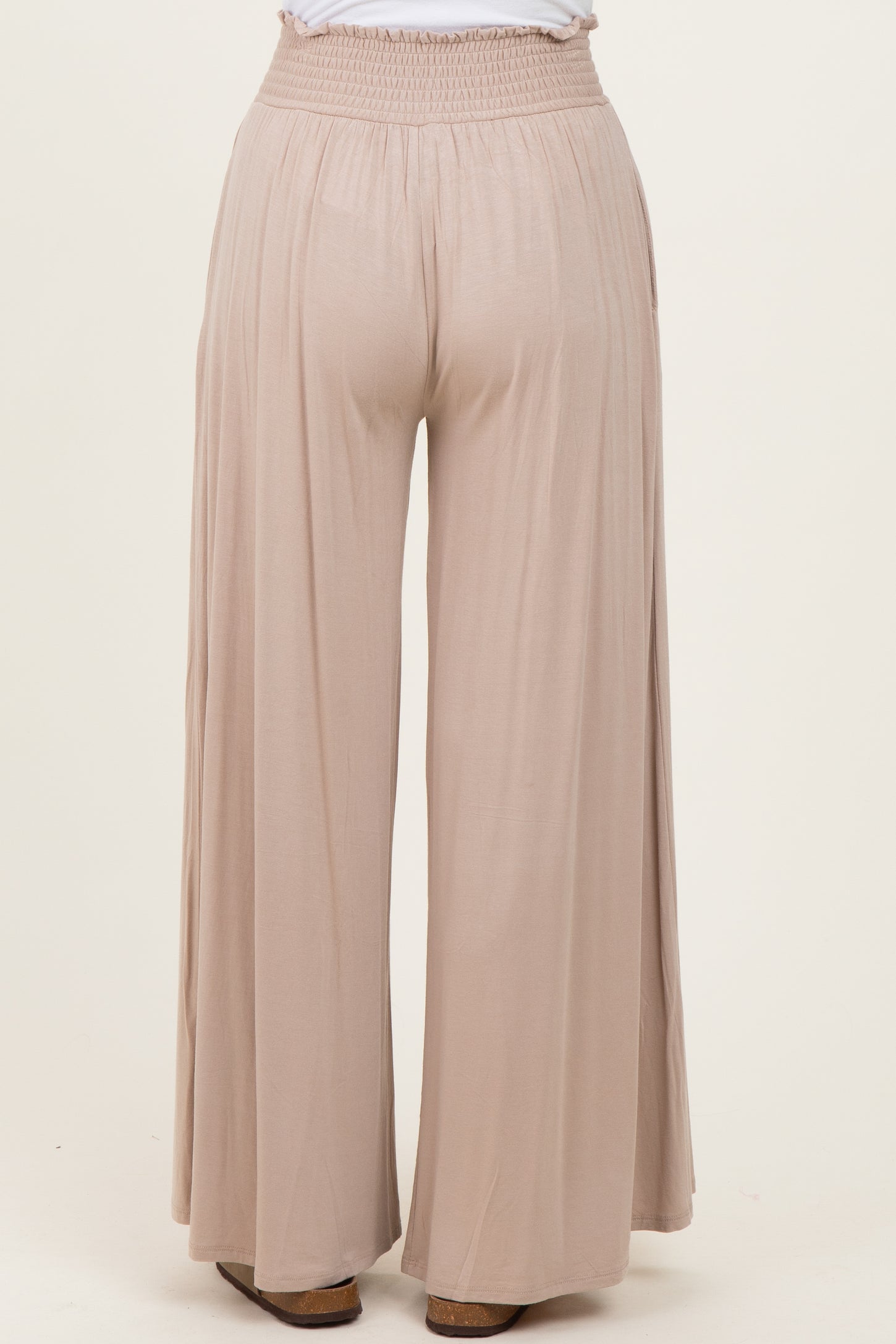 light beige wide-leg pants with an elastic waistband, viewed from the back