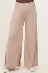 woman wearing light beige maternity wide leg pants with a relaxed fit and an elastic waistband