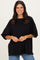 woman wearing a black oversized t-shirt with short sleeves and smiling at the camera