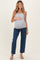 woman wearing a gray ribbed maternity tank top and blue jeans, holding her baby bump