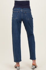 woman wearing maternity blue jeans with a supportive belly band, standing with her back to the camera