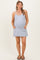 woman wearing a light gray maternity dress with a scoop neckline and side pockets, showcasing her baby bump