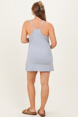woman wearing a gray maternity tank dress, showing the back view and adjustable straps