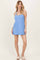 woman wearing a light blue sleeveless casual dress with two front pockets