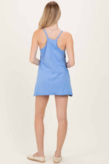 woman wearing a light blue sleeveless dress with a relaxed fit and adjustable straps, viewed from the back