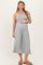 woman wearing a gray strapless jumpsuit, showing her baby bump with a relaxed fit and cropped wide legs
