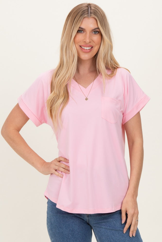 woman wearing a light pink short sleeve v-neck top with a front pocket and casual fit