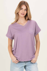 woman wearing a lavender v-neck short sleeve t-shirt with a chest pocket and rolled sleeves