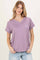 woman wearing a lavender v-neck short sleeve t-shirt with a chest pocket and rolled sleeves