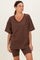woman wearing a brown oversized v-neck t-shirt and matching bike shorts