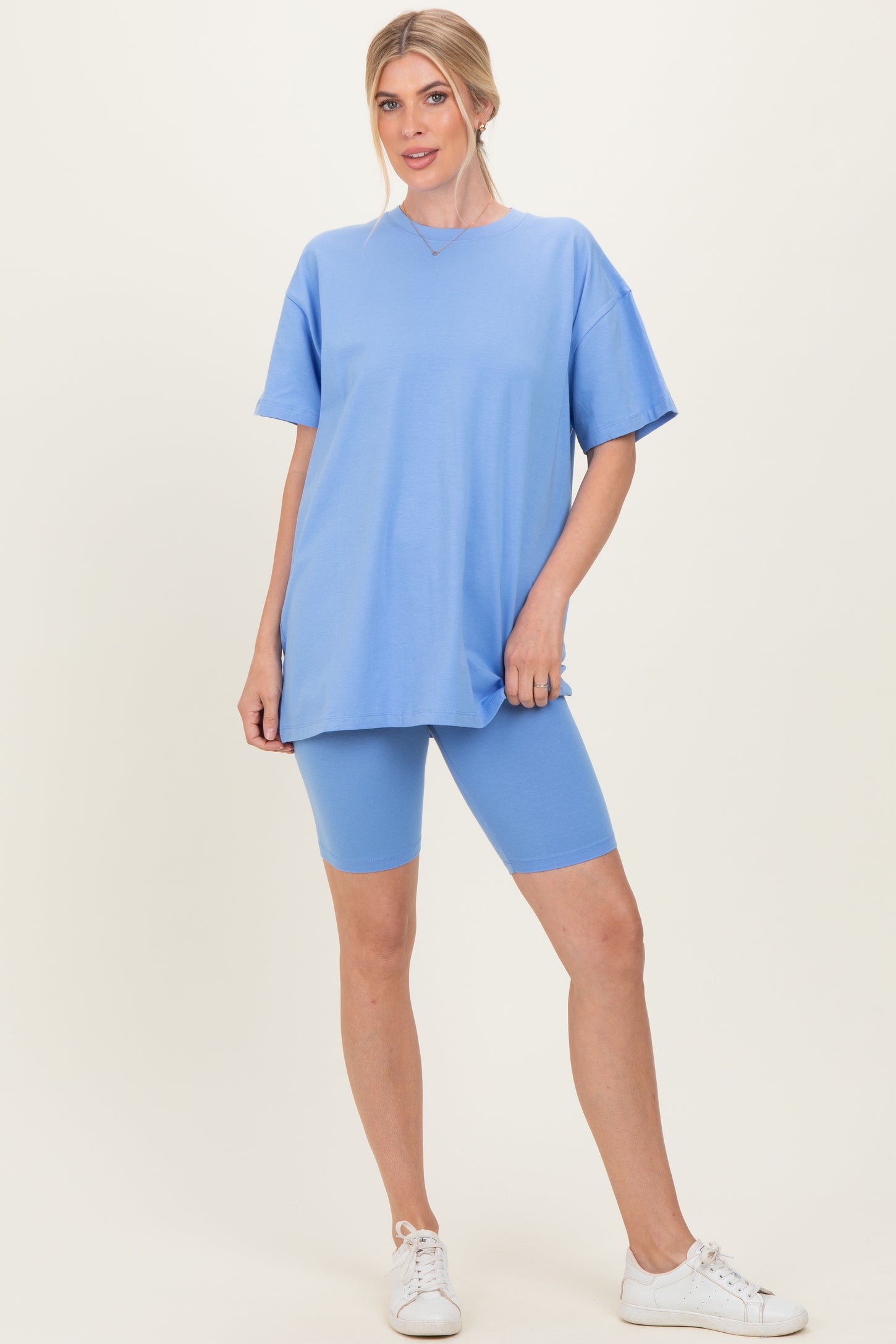 woman wearing a light blue oversized t-shirt and matching blue biker shorts