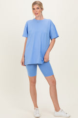 woman wearing a light blue oversized t-shirt and matching blue biker shorts