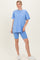 woman wearing a light blue oversized t-shirt and matching blue biker shorts