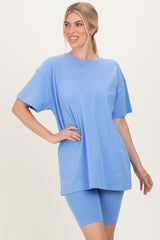 woman wearing a light blue oversized t-shirt and matching bike shorts