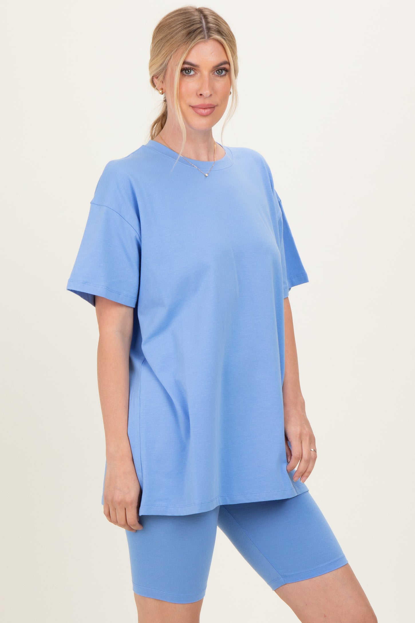 woman wearing a light blue oversized t-shirt with matching blue bike shorts