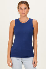 woman wearing a navy blue sleeveless ribbed top with a round neckline and light blue jeans