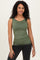 woman wearing a fitted olive green tank top and black jeans, smiling at the camera