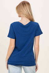 woman wearing a navy blue short sleeve t-shirt viewed from the back with a v-neckline