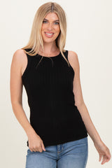 woman wearing a black ribbed sleeveless top with a scoop neckline and casual jeans