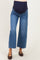 woman wearing a pair of blue maternity wide-leg jeans with a navy belly panel
