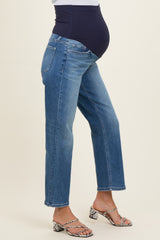 woman wearing blue maternity jeans with a high waistband and a visible baby bump