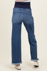 woman wearing dark blue maternity jeans with a stretchy waistband and rolled cuffs, view from the back