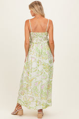 woman wearing a floral print maternity maxi dress with smocked back and adjustable straps