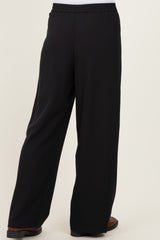 black wide-leg trousers with elastic waistband, shown from the back