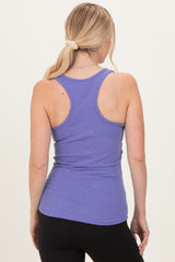 woman wearing a lavender ribbed tank top, viewed from the back, paired with black leggings