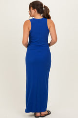 woman wearing a sleeveless royal blue maternity maxi dress, shown from the back