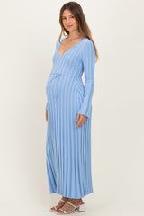 woman wearing a light blue striped long sleeve maternity dress with a tie waist and visible baby bump
