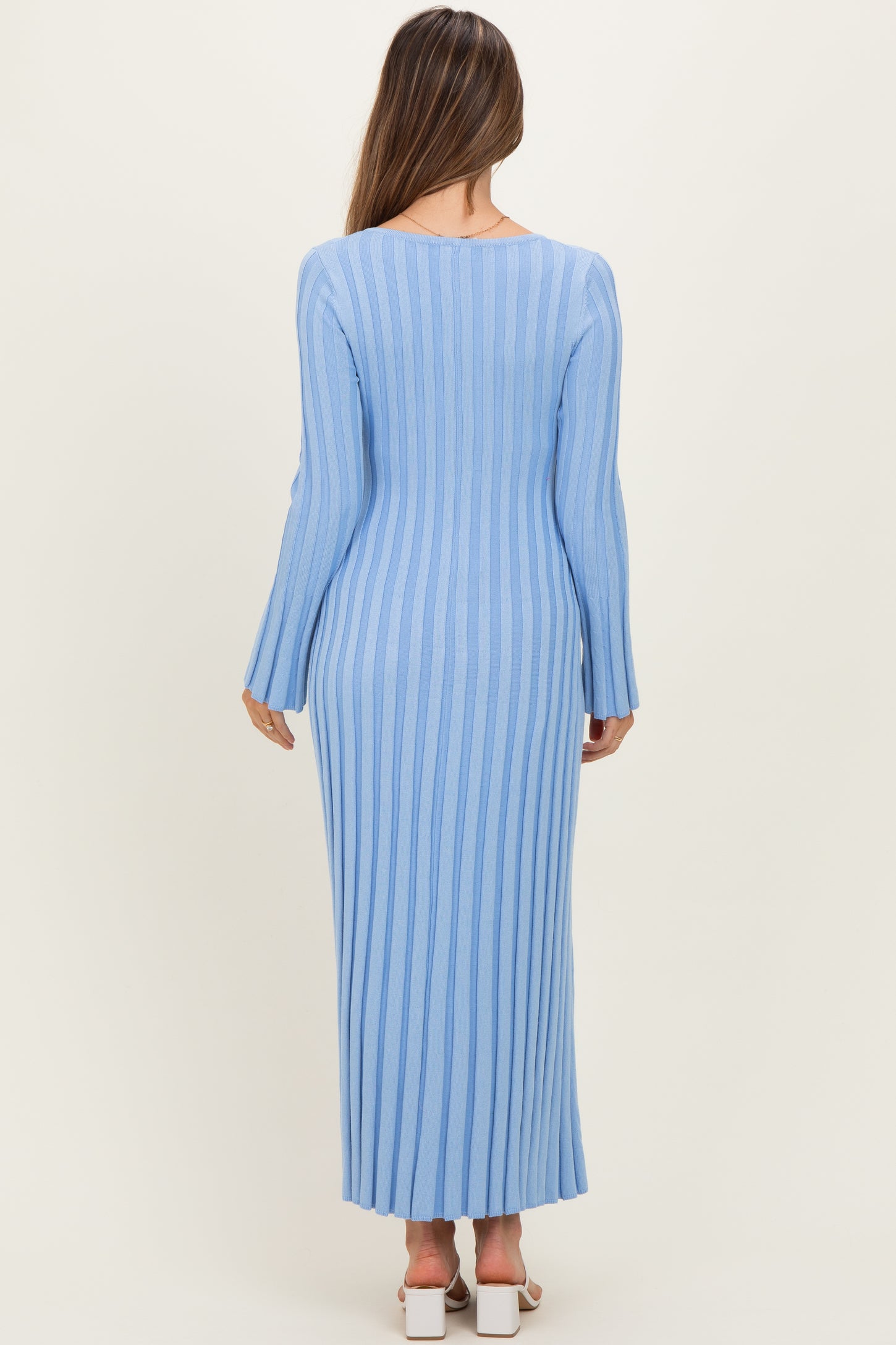 woman wearing a light blue long sleeve ribbed maternity dress from the back
