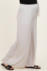 maternity wear light gray wide-leg pants with an elastic waistband and drawstring, model showing a baby bump