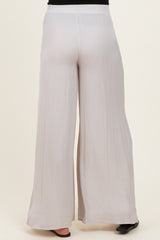 woman wearing light gray maternity wide-leg pants, showcasing a relaxed fit and elastic waistband