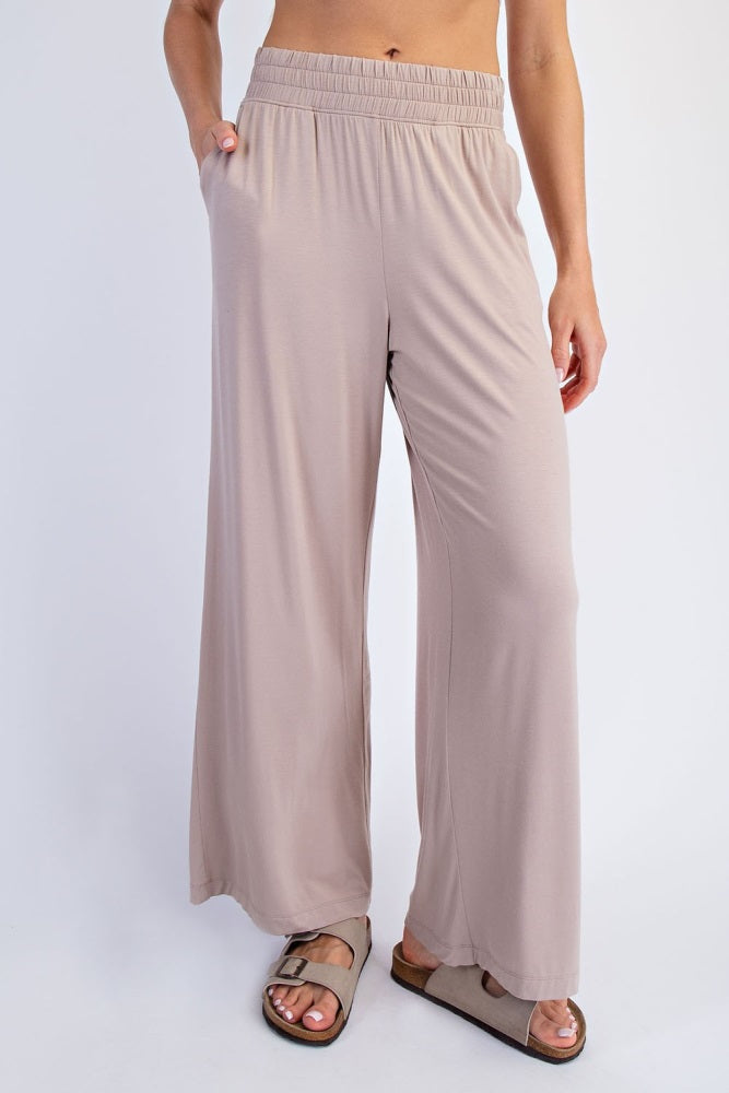woman wearing beige wide-leg pants with an elastic waistband and side pockets