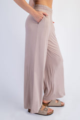 woman wearing beige wide-leg pants with an elastic waistband and side pockets