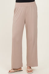 woman wearing beige wide-leg pants with an elastic waistband and side pockets