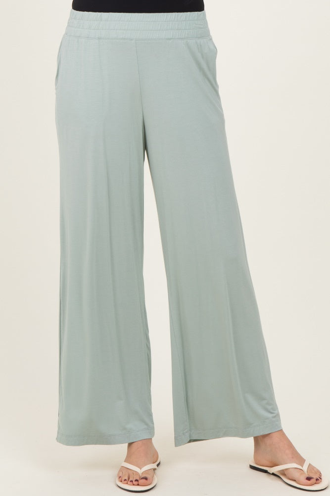 woman wearing light green wide-leg pants with an elastic waistband and side pockets