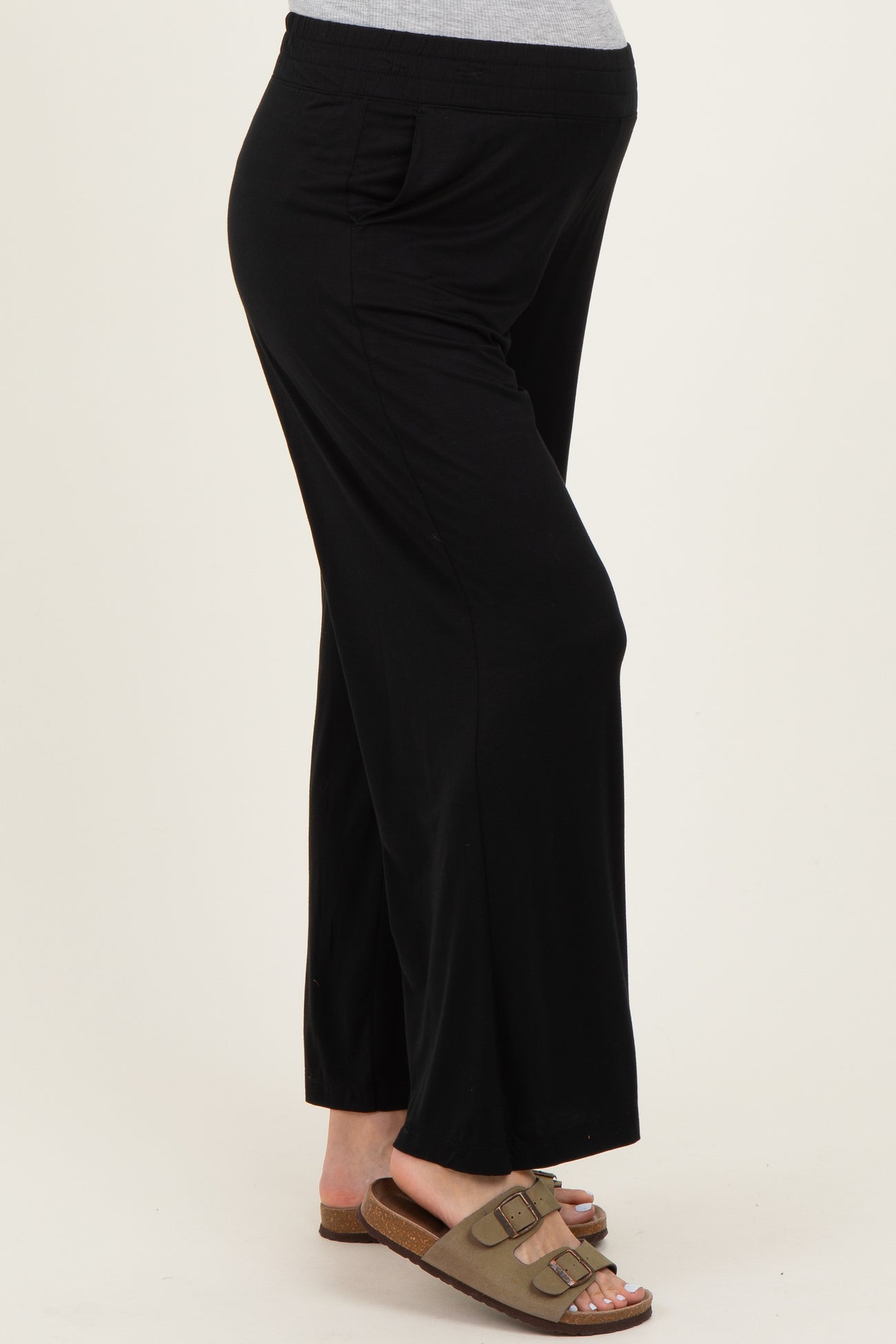 maternity wear black wide-leg pants with side pockets and stretchy waistband, model showing baby bump