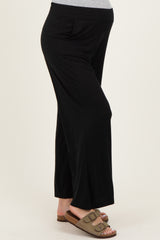 maternity wear black wide-leg pants with side pockets and stretchy waistband, model showing baby bump