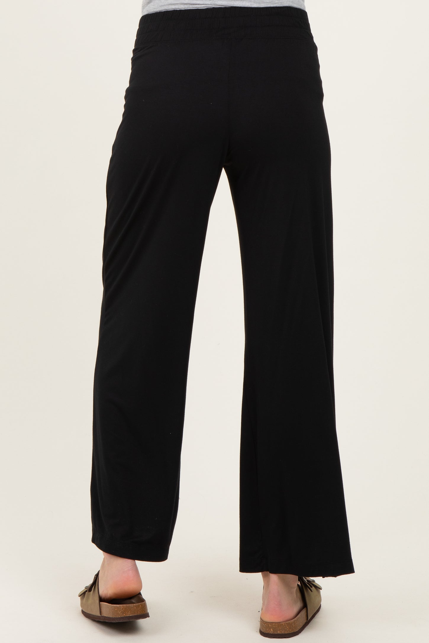 woman wearing black maternity wide-leg pants, seen from the back