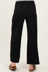 woman wearing black maternity wide-leg pants, seen from the back