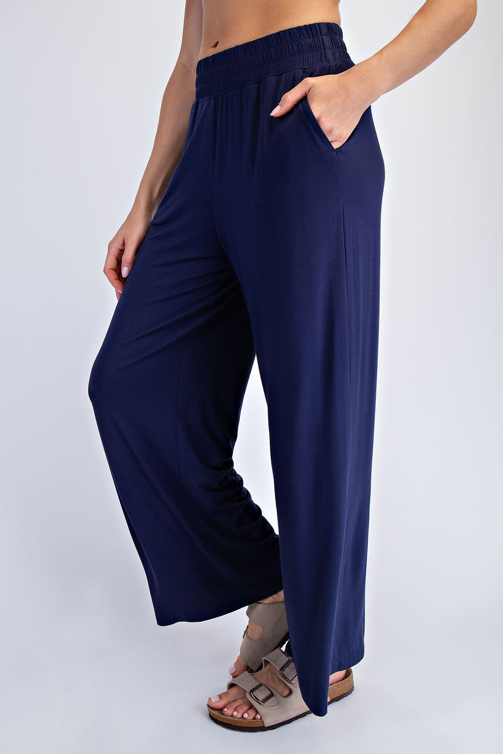 woman wearing navy wide-leg pants with an elastic waistband and side pockets
