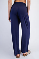 woman wearing navy blue wide-leg pants, viewed from the back